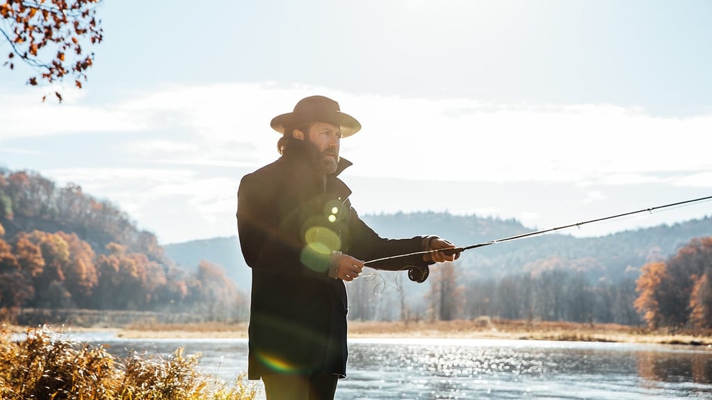 A man standing next to a body of water