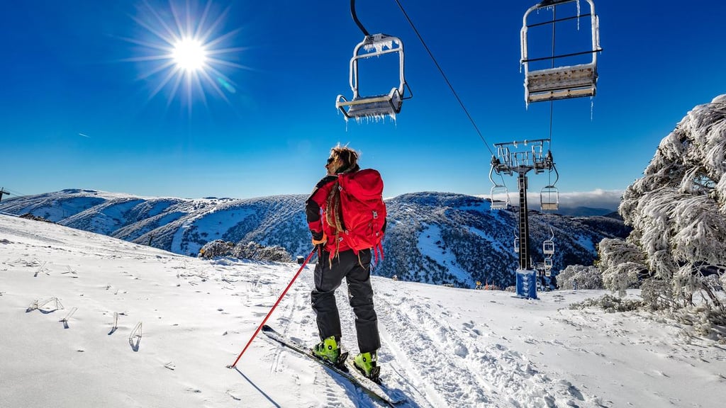 A person riding skis down a snow covered slope