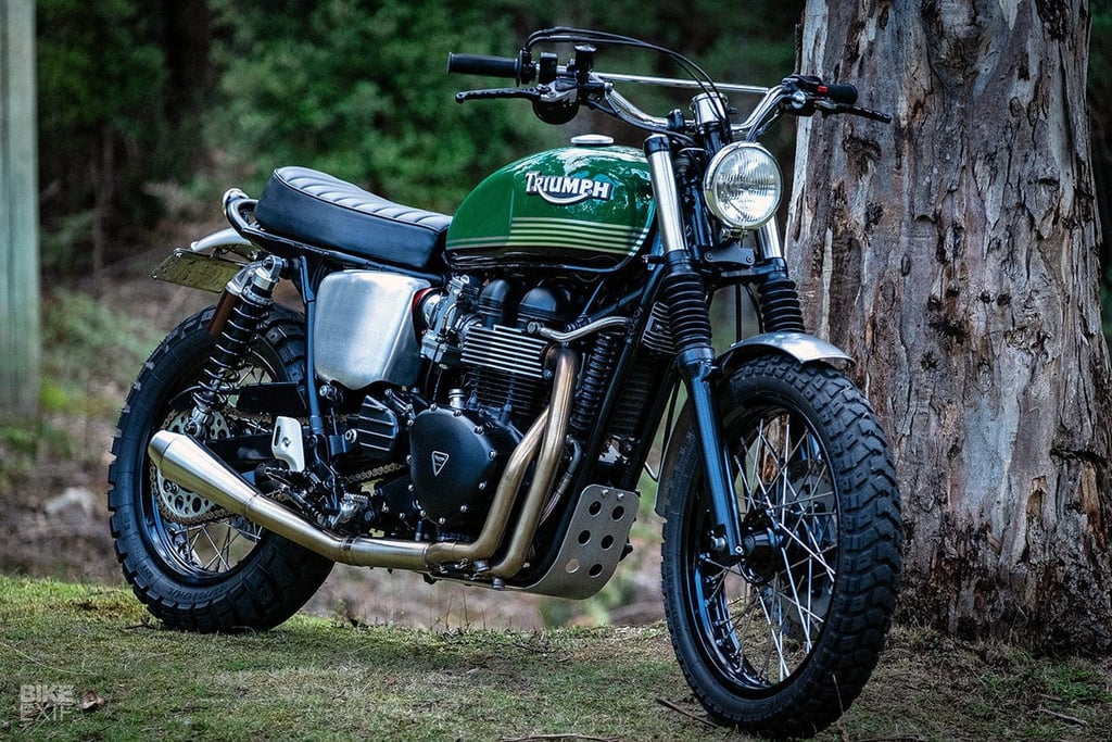 A motorcycle parked on the side of a dirt field