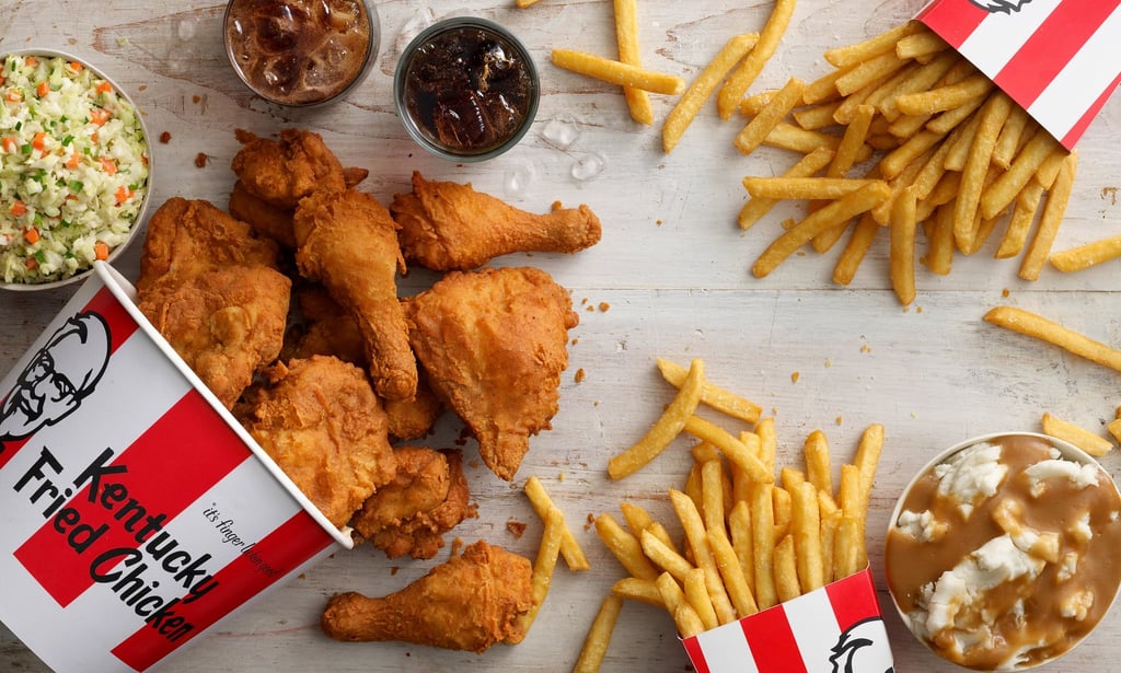 A plate of hot dogs and fries on a table