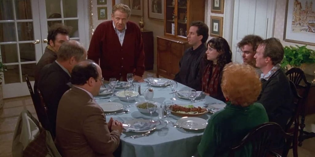 A group of people sitting at a table with wine glasses