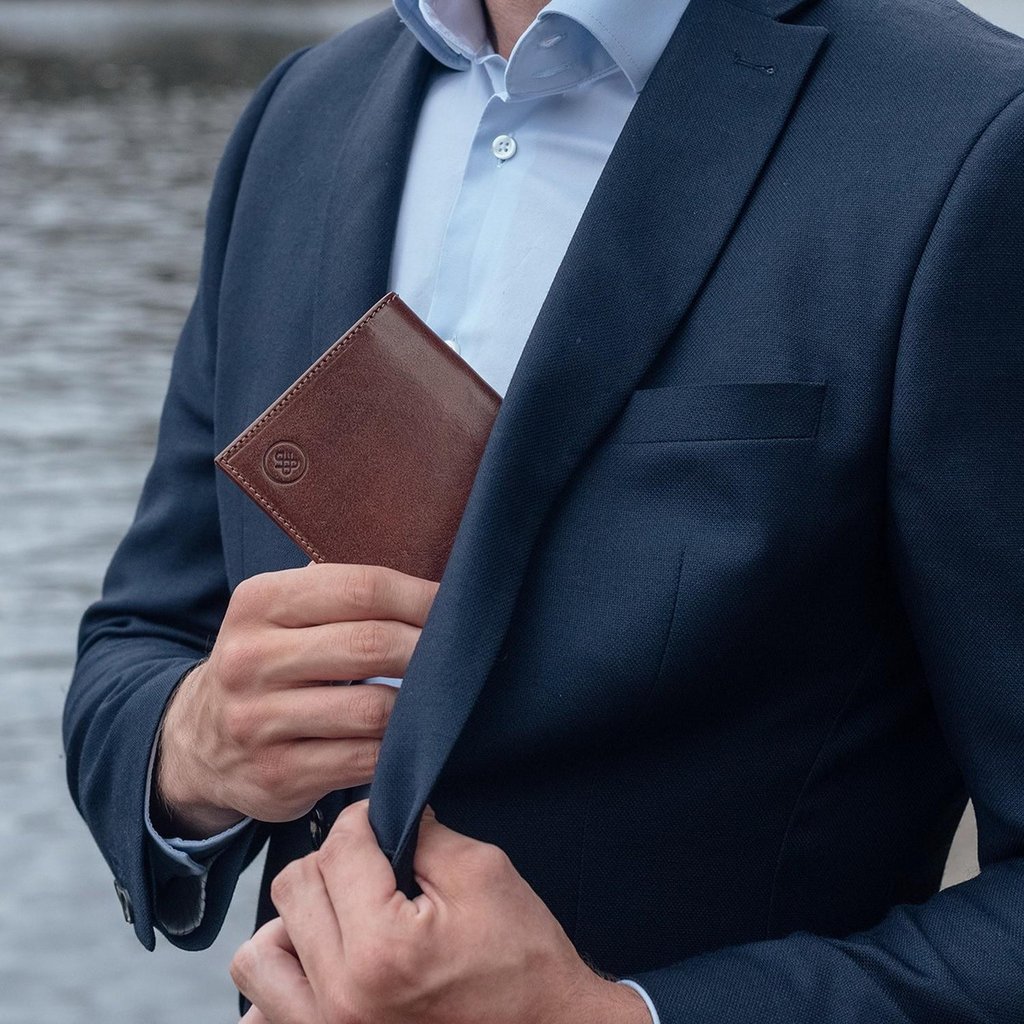 A person wearing a suit and tie talking on a cell phone