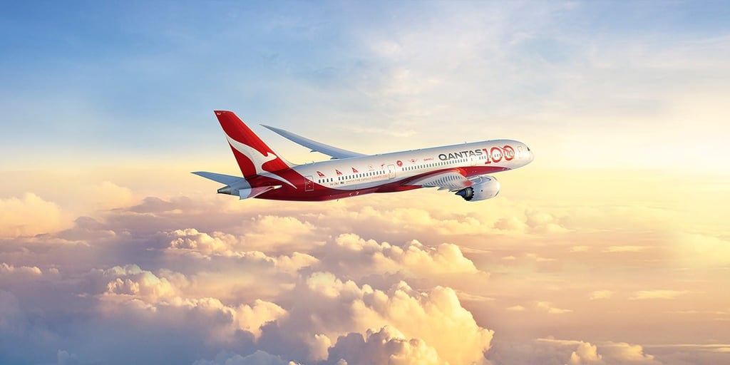 A large passenger jet flying through a cloudy sky