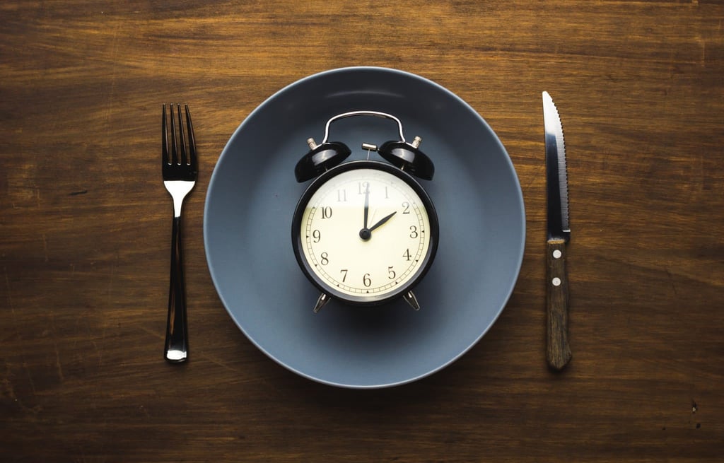 A clock sitting on top of a wooden table