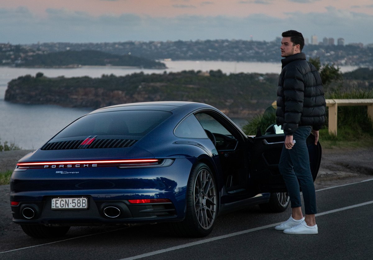 A man standing in front of a car