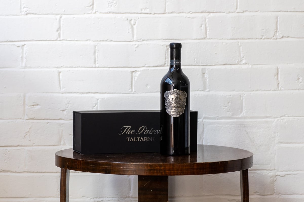 A bottle of wine sitting on top of a wooden table
