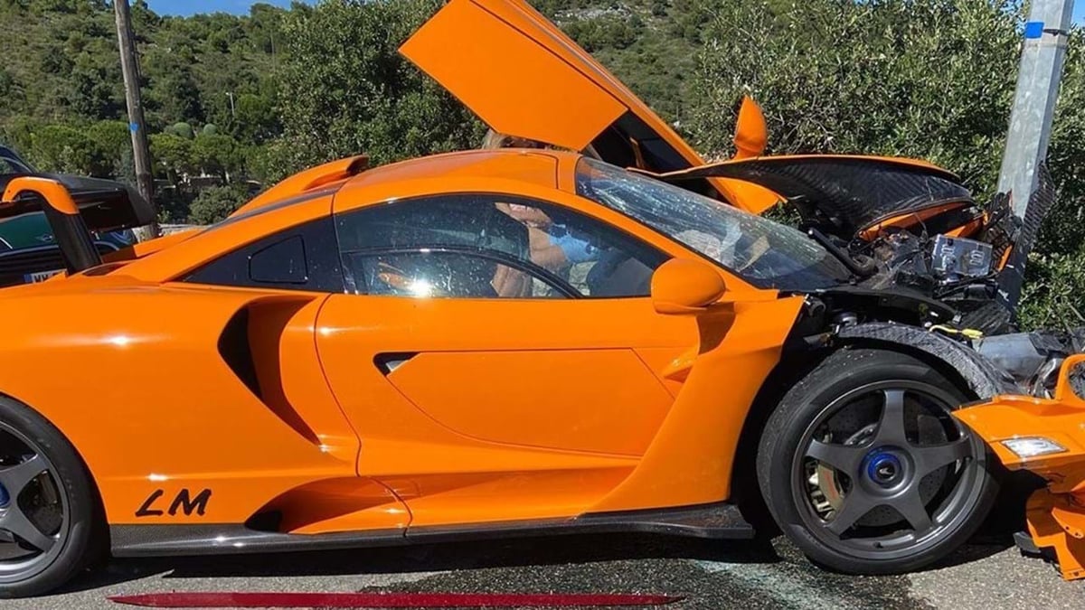 An orange car parked on the side of a road