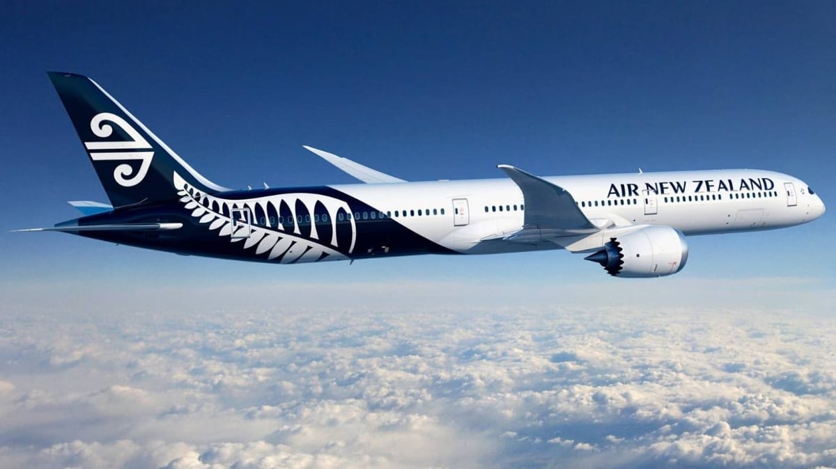 A large passenger jet flying through a blue sky