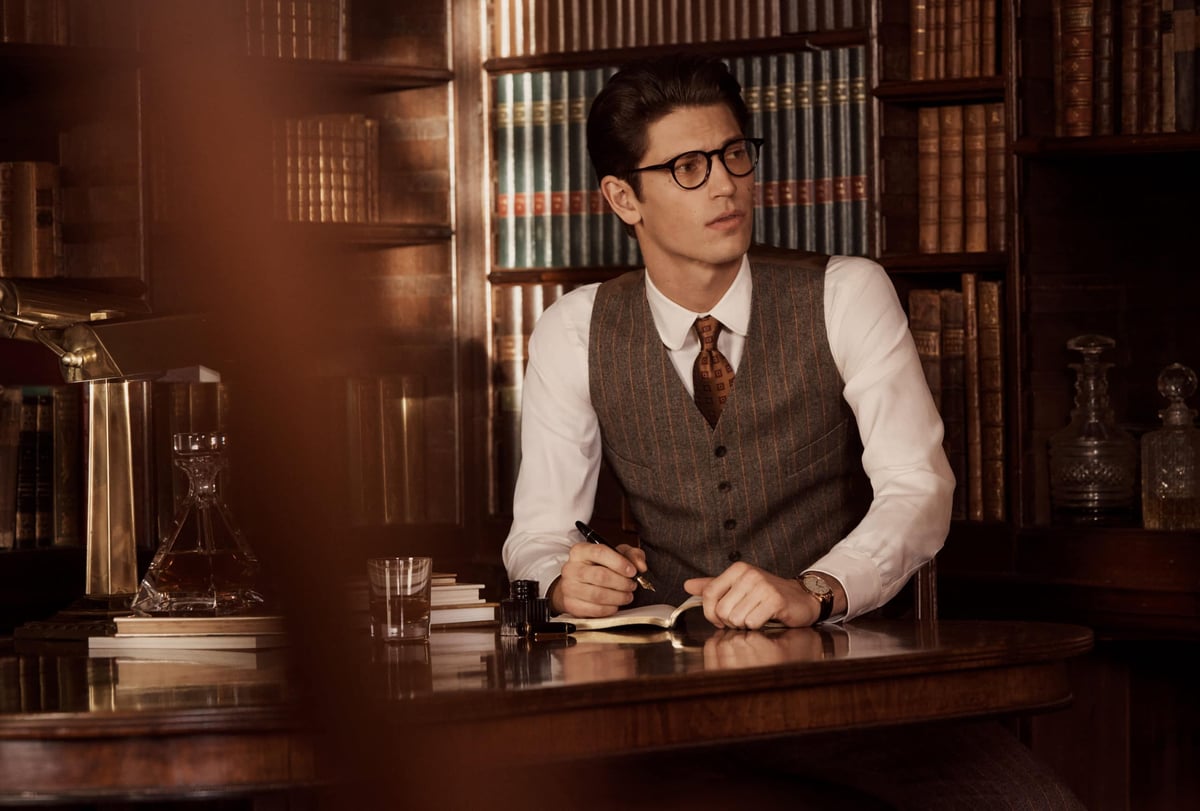 A man wearing a suit and tie sitting at a table