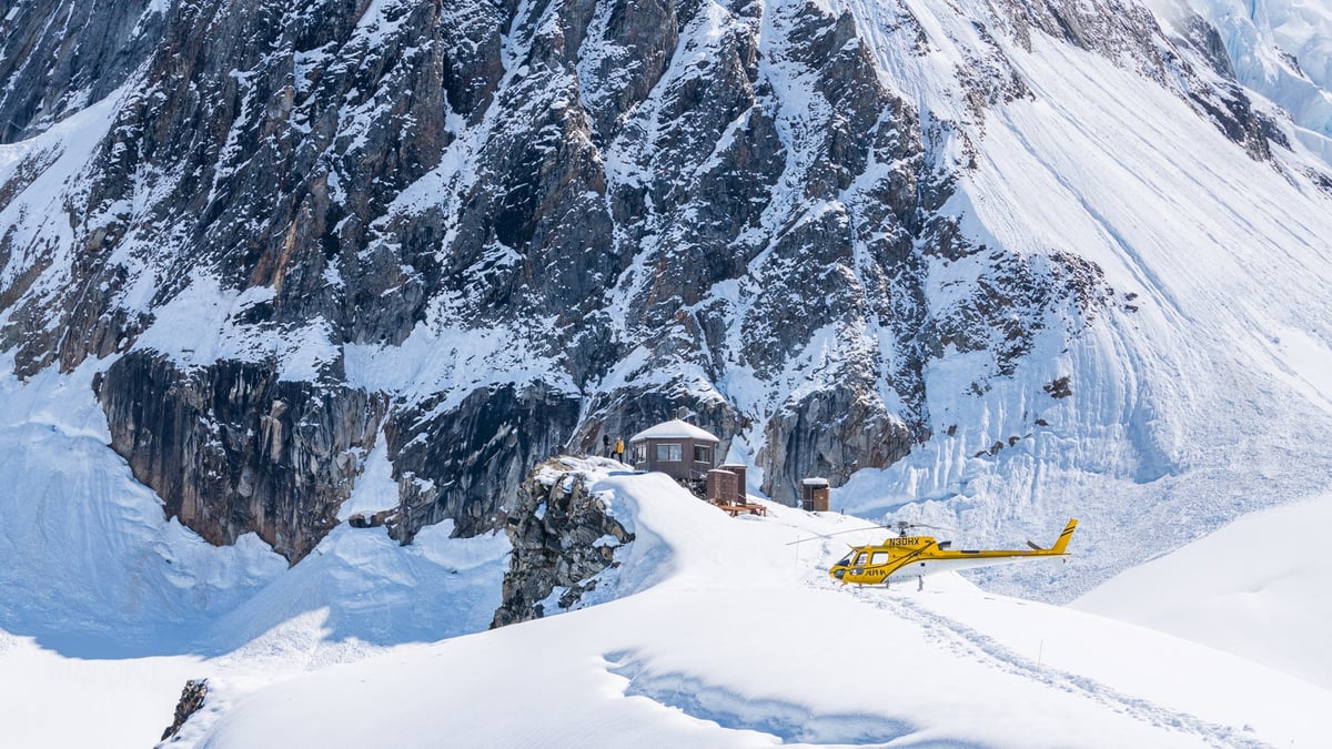 A man riding on top of a snow covered mountain