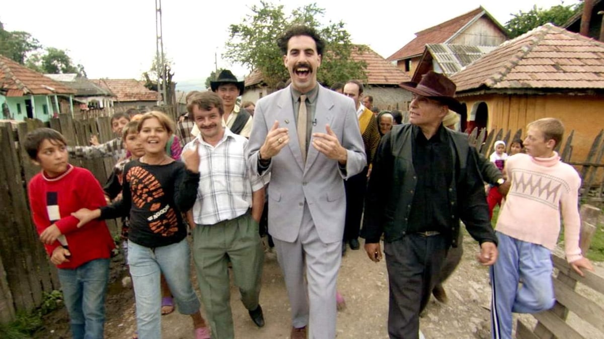 A group of people standing in front of a crowd posing for the camera