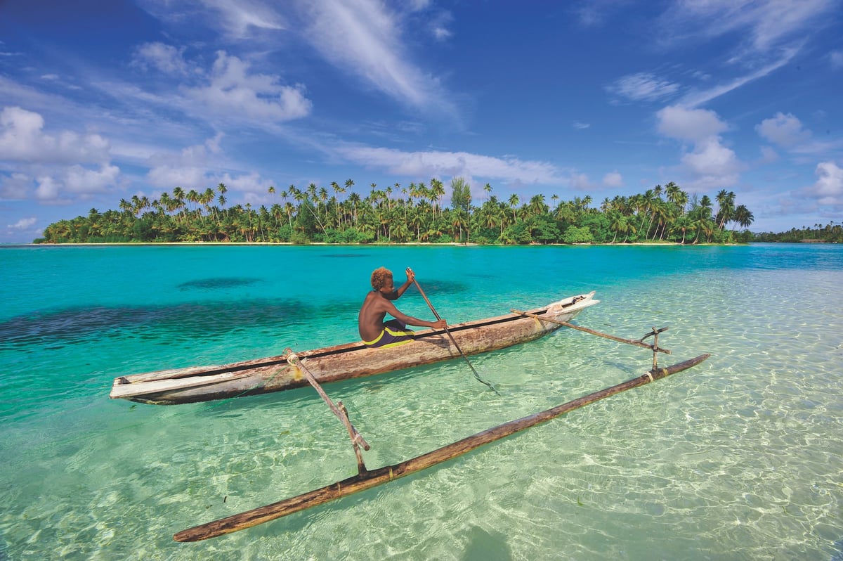 A person sitting in a boat on a body of water