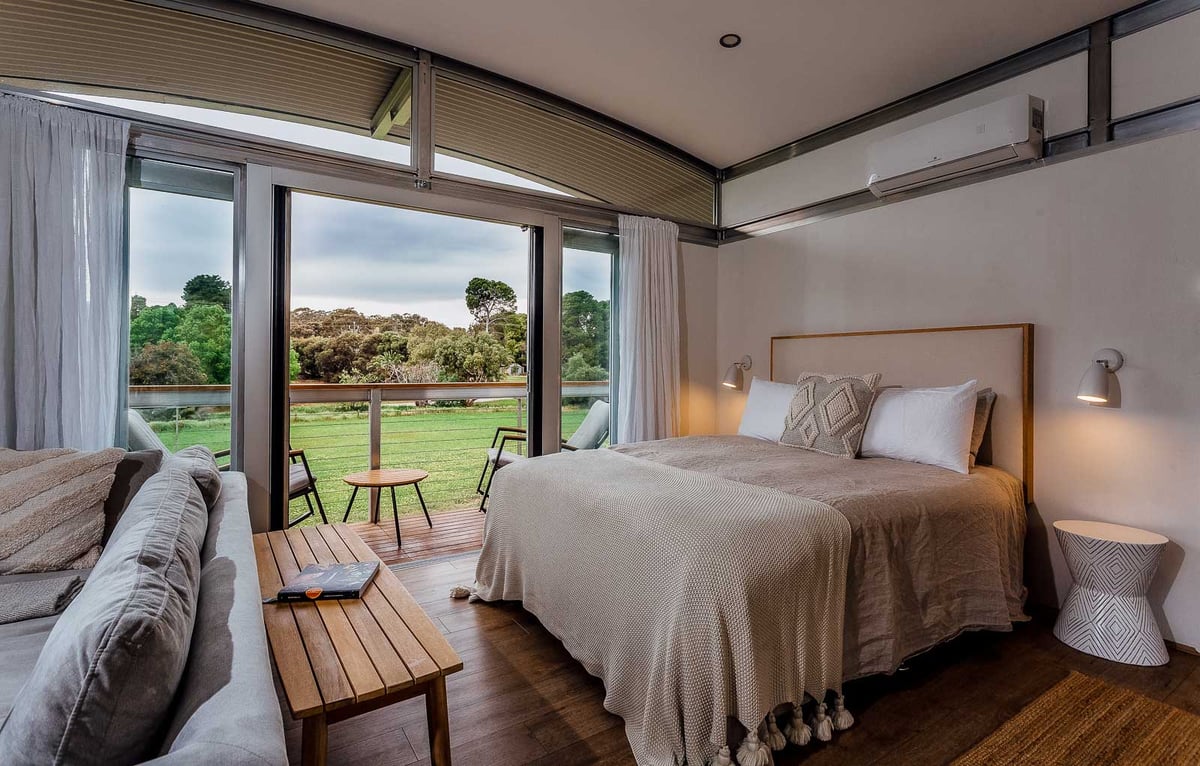 A bedroom with a large bed in a hotel room