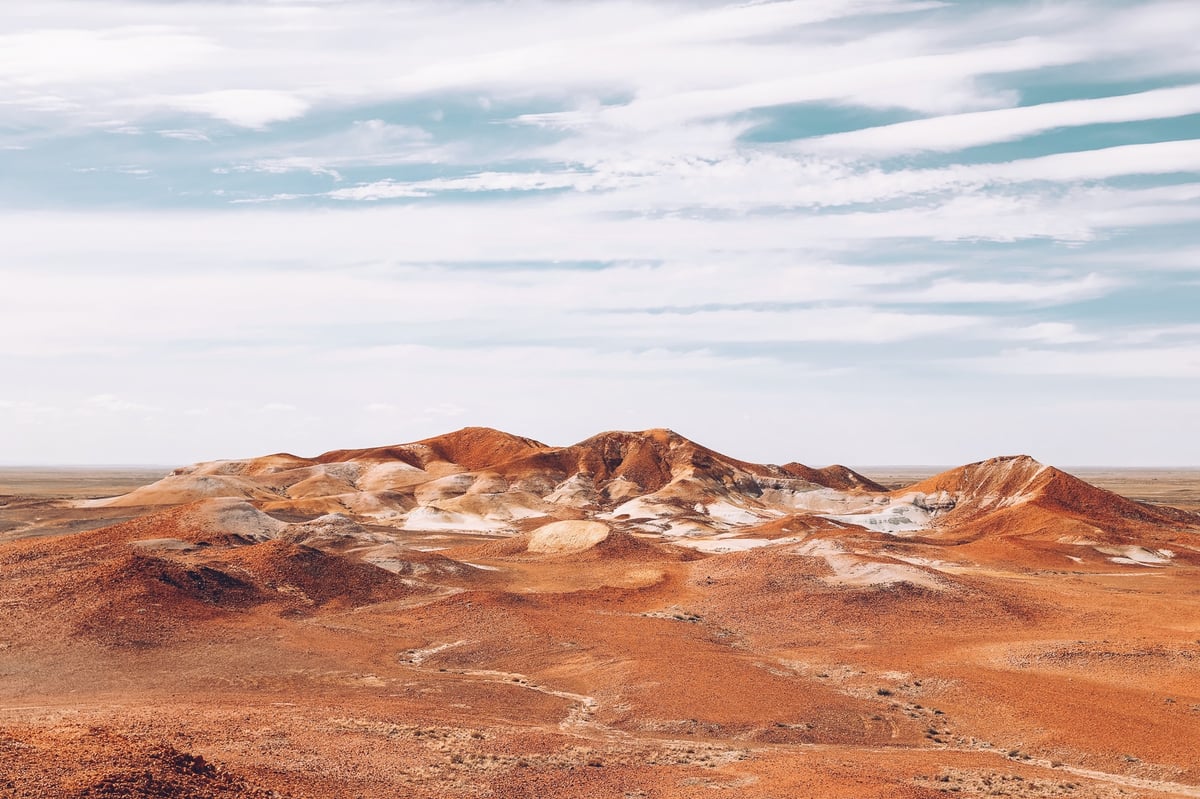 A man standing in front of a mountain