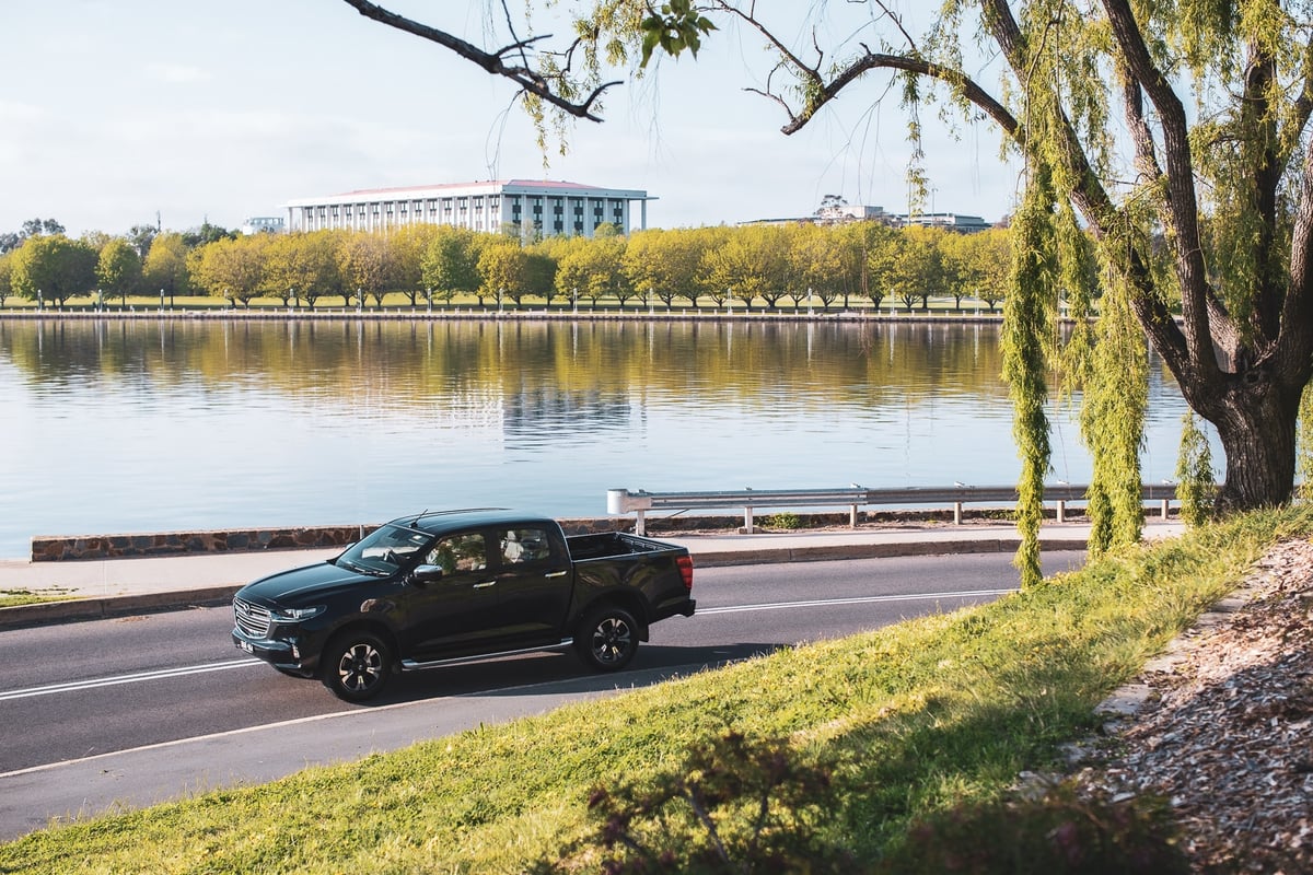 A car parked on the side of a river