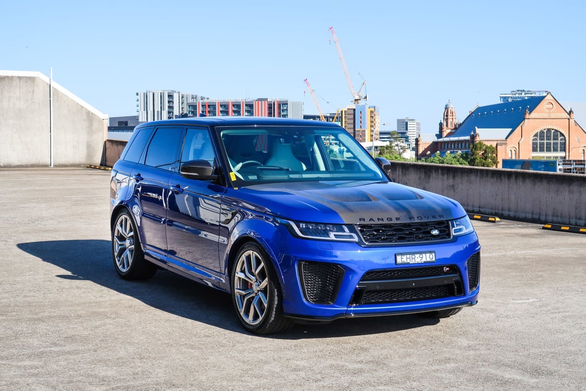 A blue car parked in a parking lot