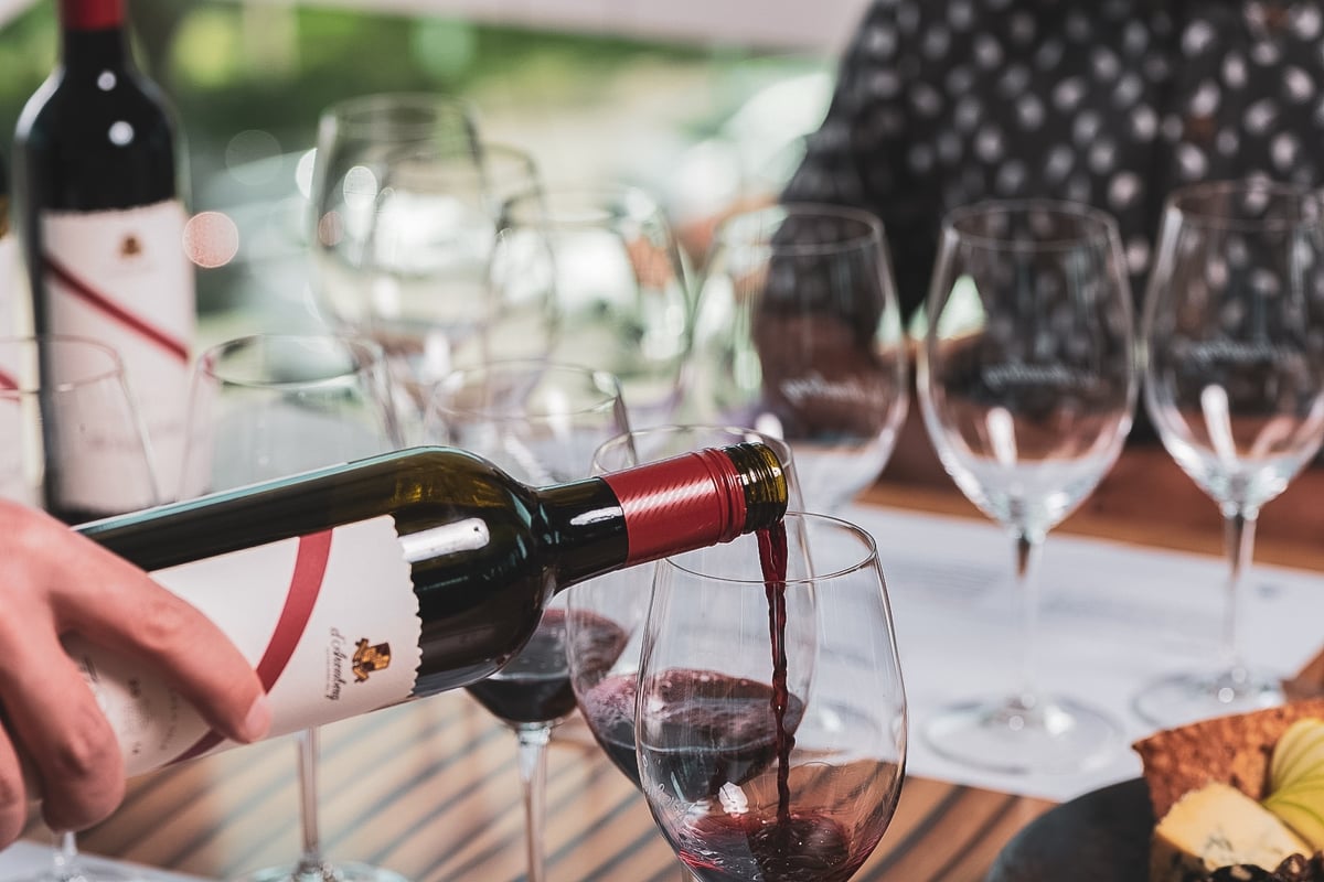 A person sitting at a table with wine glasses