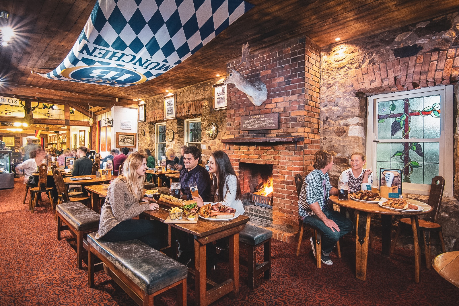 A group of people sitting at a table in a restaurant