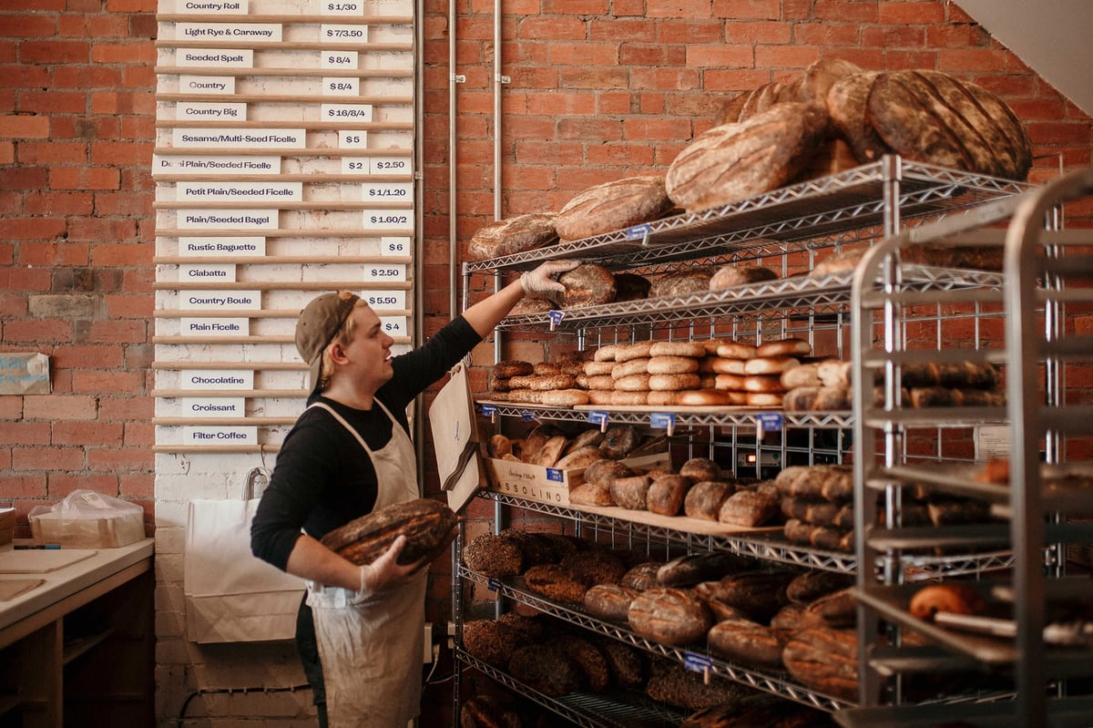 Baker grabbing some freshly baked bread at Baker Bleu.
