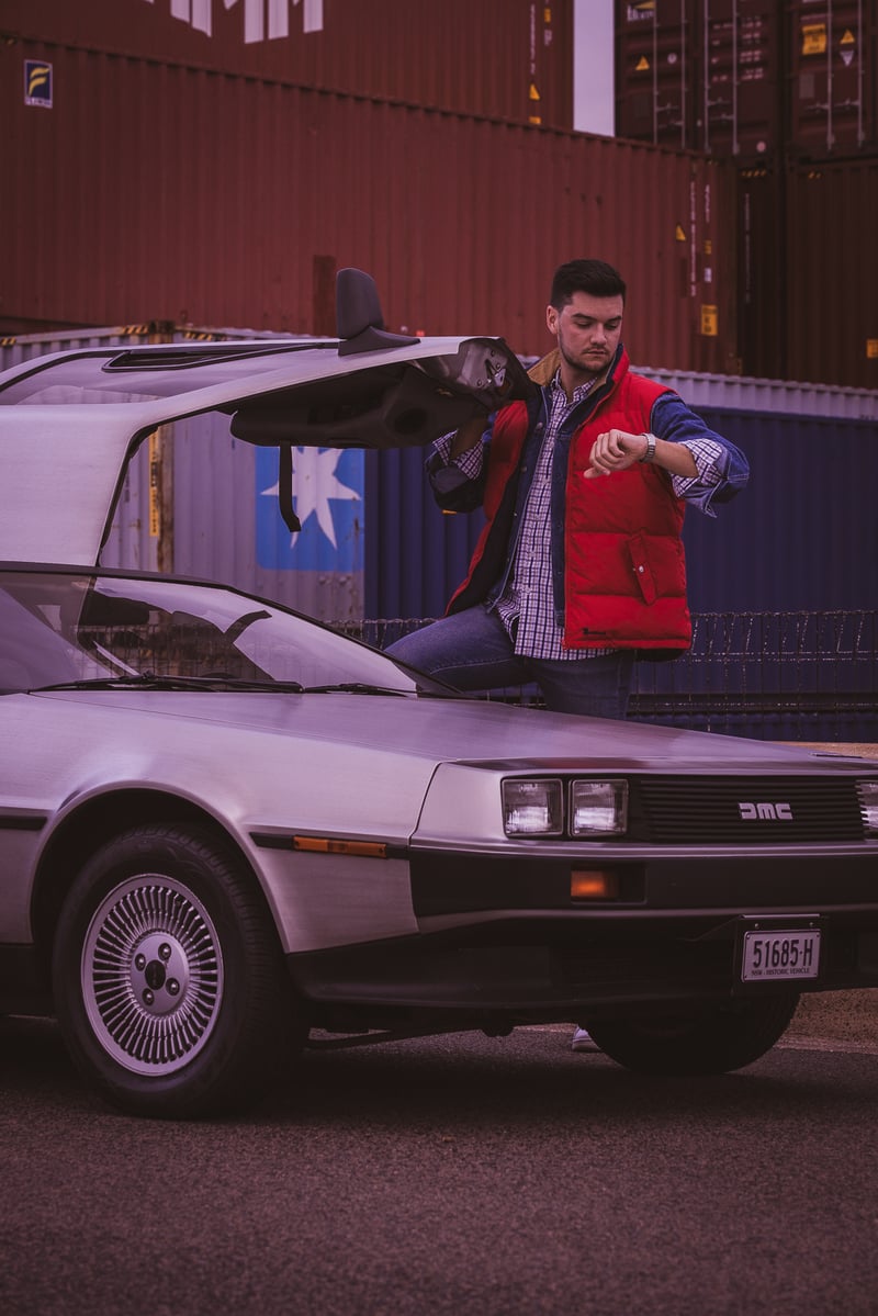 A person standing in front of a car