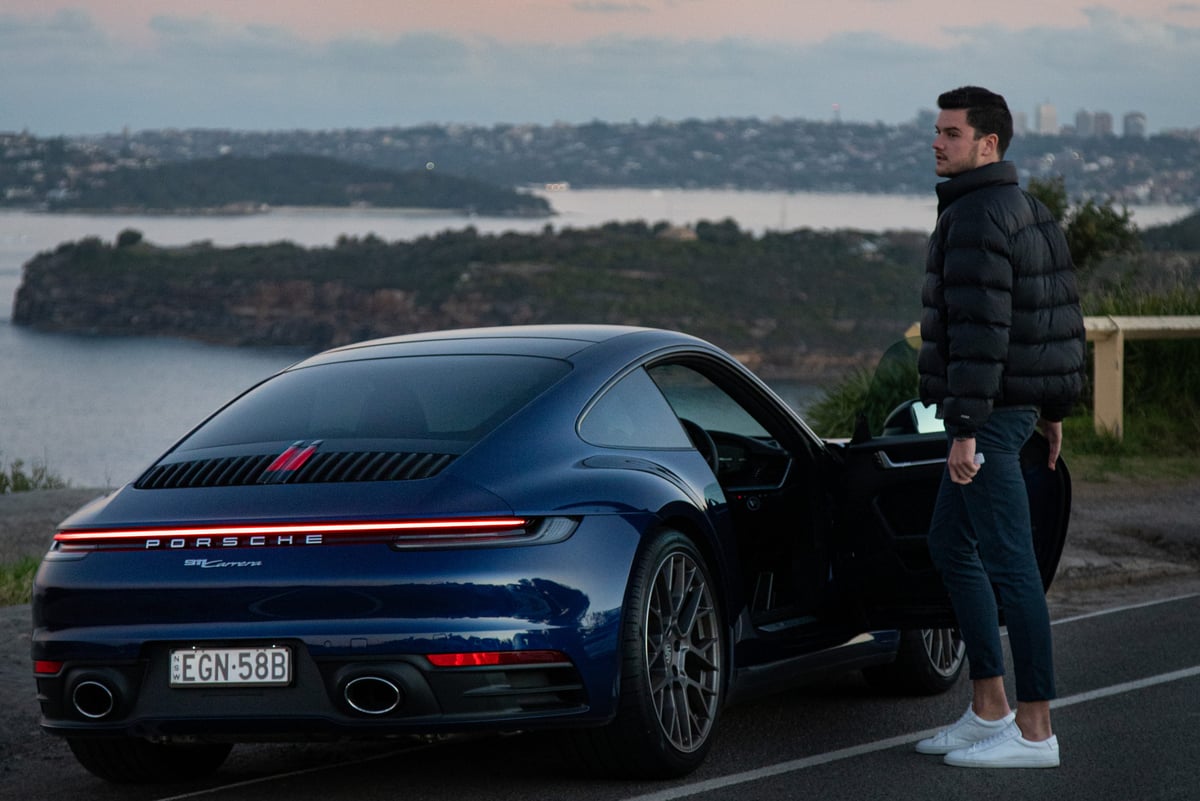 A man standing in front of a car