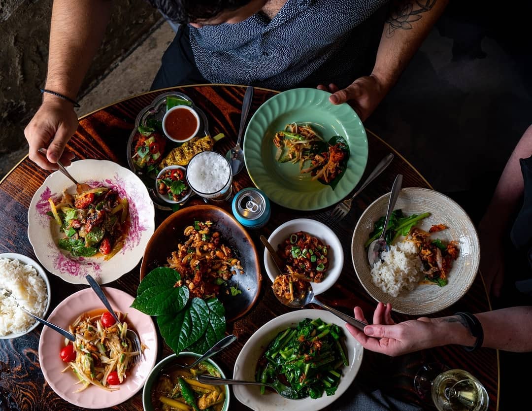 A group of people sitting at a table with a plate of food