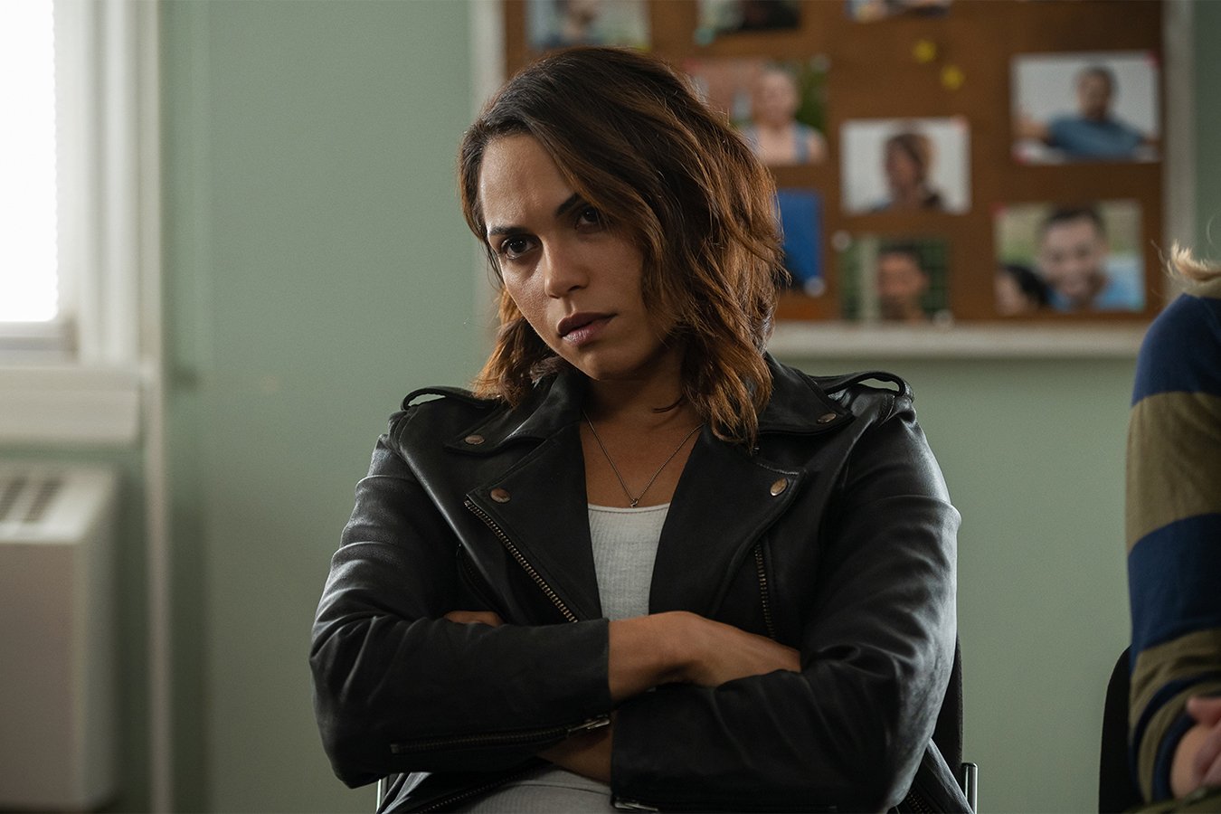 Monica Raymund standing in front of a window