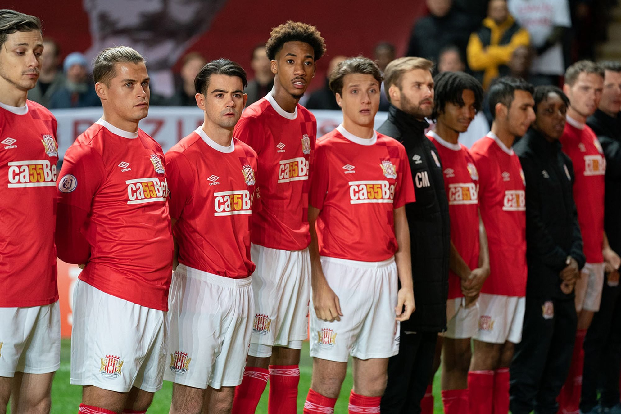 A group of football players posing for a picture