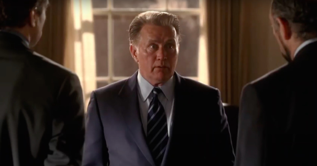Martin Sheen wearing a suit and tie looking at the camera