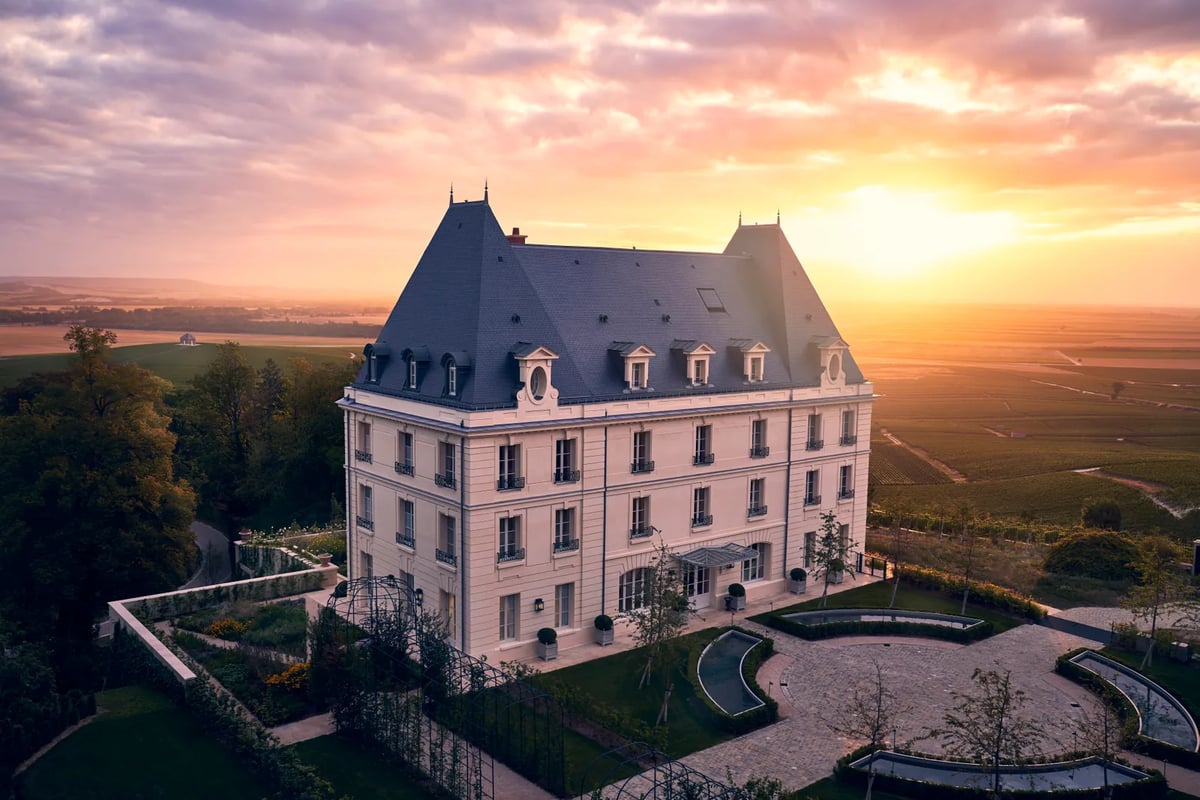 A castle like building with a sunset in the background