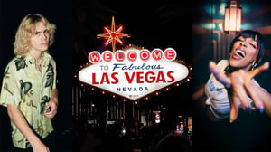 A woman standing in front of a store with Welcome to Fabulous Las Vegas sign in the background