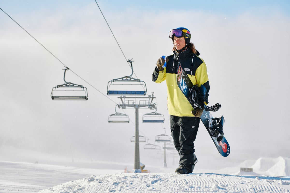 A man riding skis down a snow covered slope