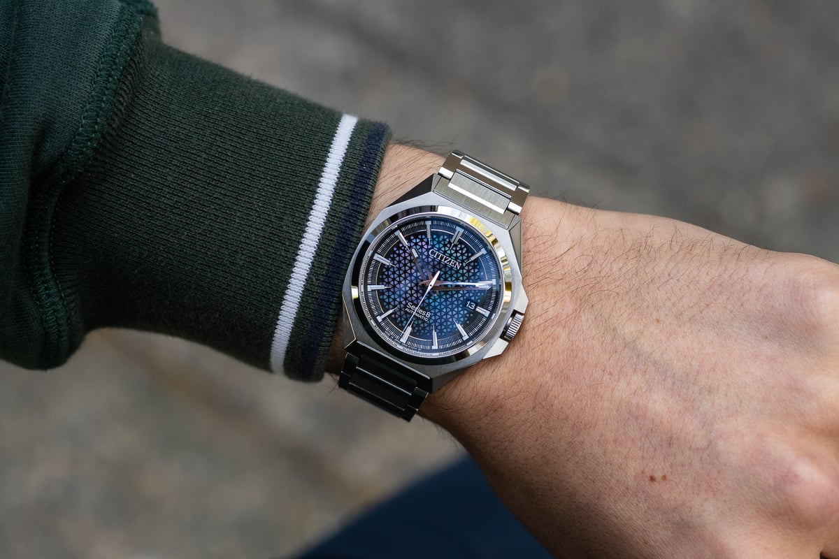 A close up of a hand holding a watch