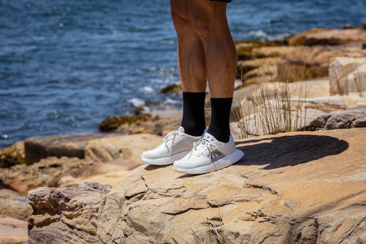 A man standing on a rocky beach