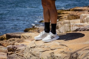 A man standing on a rocky beach