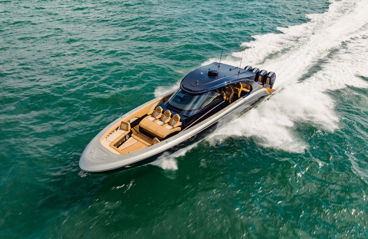 A person riding on the back of a boat in the water