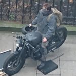 A person sitting on a motorcycle