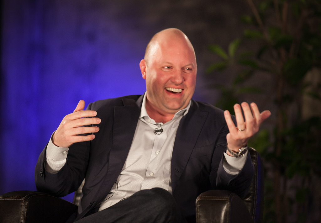 A man sitting in a chair talking on a cell phone