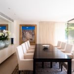 A living room filled with furniture and vase on a table