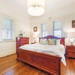A bedroom with a large bed in a room