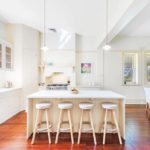 A kitchen with a wood floor