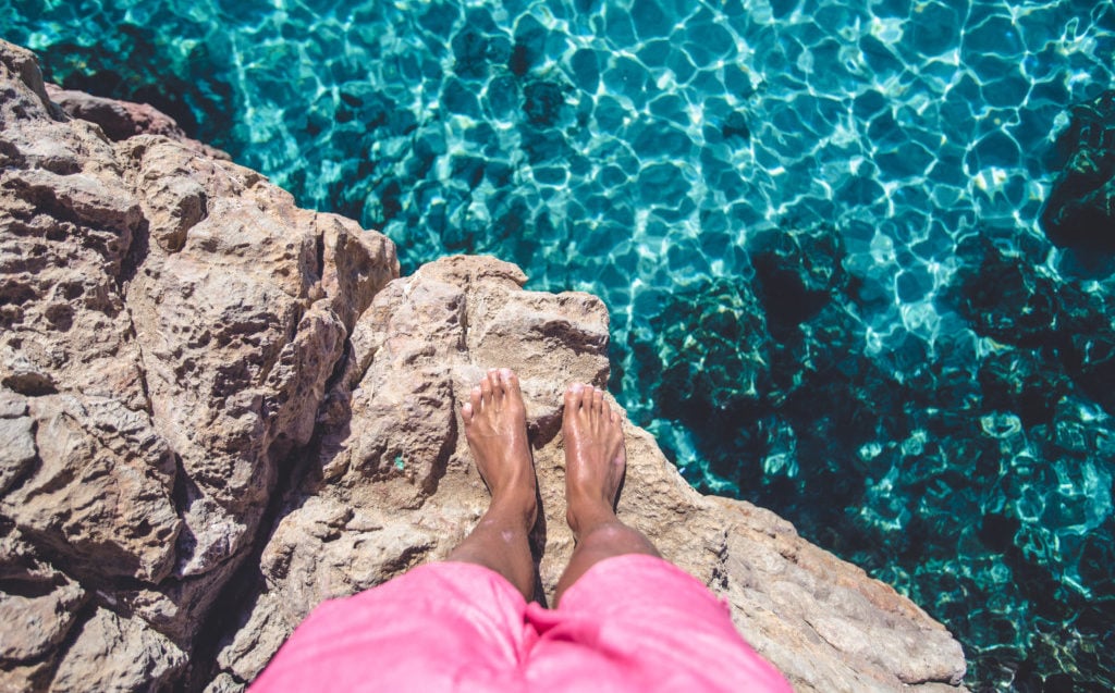 A person sitting on a rock