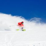 A man riding skis down a snow covered slope