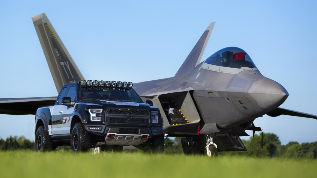 A fighter jet sitting on top of a grass covered field