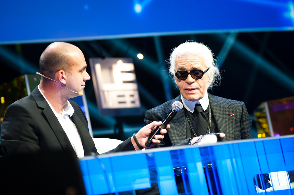 A man wearing a blue screen on a stage