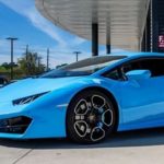A blue car parked in a parking lot