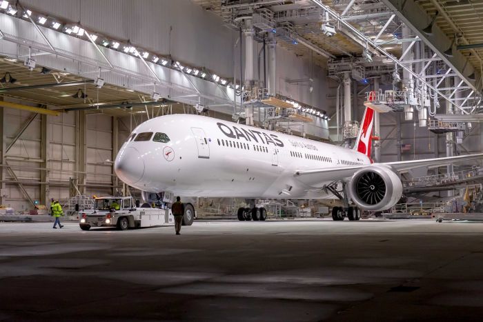 A large passenger jet sitting on top of a building