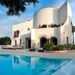 A house with a pool in front of Bait al Zubair