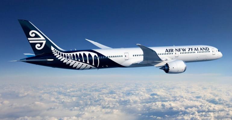 A large passenger jet flying through a blue sky