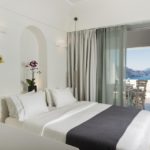 A bedroom with a large bed in a hotel room